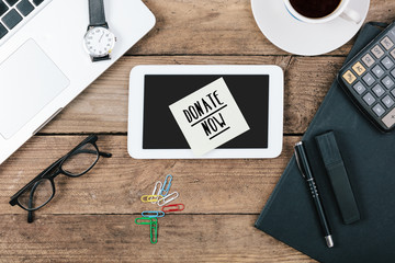 Headline Donate Now on paper note