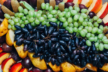 Platter of assorted fresh fruit. Beautiful fruit dessert on a celebratory table