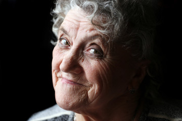 Smile grandmother face on a black
