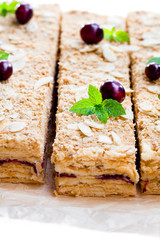 Napoleon  cake with cranberry and mint on white background