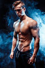 Strong bodybuilder with six pack, perfect abs, shoulders, biceps, triceps and chest, personal...