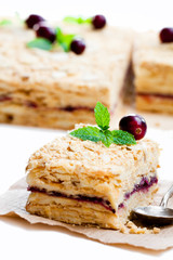 Napoleon  cake with cranberry and mint on white background