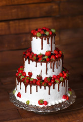 Strawberry cake on a wooden background.