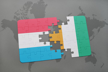 puzzle with the national flag of luxembourg and cote divoire on a world map