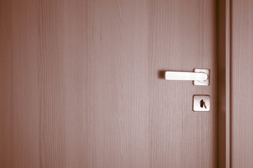 Closed doors wit key in keyhole
