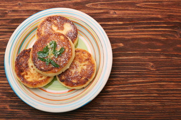 Cheese pancakes fried in a pan.