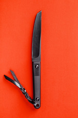 Black knife on yellow background. survival and bushcraft concept