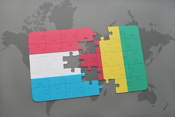 puzzle with the national flag of luxembourg and guinea on a world map
