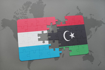 puzzle with the national flag of luxembourg and libya on a world map
