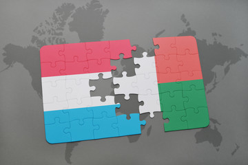 puzzle with the national flag of luxembourg and madagascar on a world map