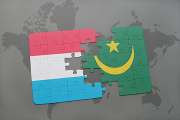 puzzle with the national flag of luxembourg and mauritania on a world map