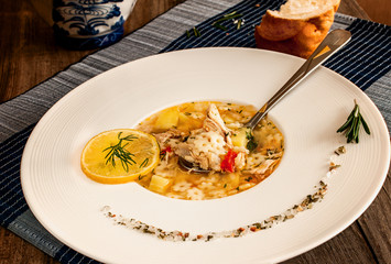 chicken soup on a white plate with spices