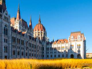 Obraz premium Daytime view of historical building of Hungarian Parliament, aka Orszaghaz, with typical central dome in Budapest, Hungary, Europe. It is notable landmark and seat of the National Assembly of Hungary