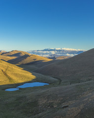 Panoramic view of beautiful landscape with Italian Gran Sasso peak at Campo Imperatore plateau in the Apennine Mountains, Abruzzo, Italy