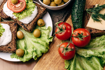 Sandwiches of homemade bread with cheese sauce or cream, lettuce, tomatoes