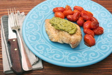 tasty baked chicken breasts covered with basil pesto sauce