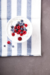 Yogurt with Chia seeds and fresh Raspberries,Blueberries and Honey.Concept of Healthy Eating.Breakfast.Copy space. selective focus.