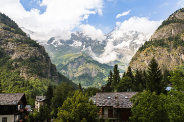 Towering peaks and clouds over Courmayeur, Italy just after a rain storm in summer
