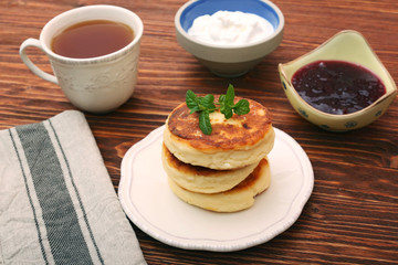 Cheese pancakes fried in a pan.