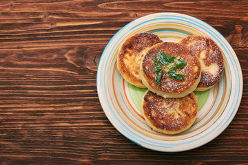 Cheese pancakes fried in a pan.