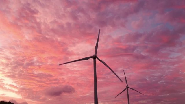 Windmills truning in the wind at Sunset in Hawaii 02