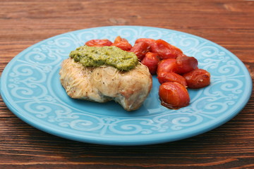 tasty baked chicken breasts covered with basil pesto sauce