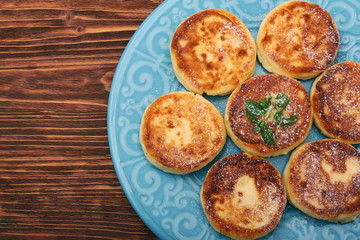 Cheese pancakes fried in a pan.