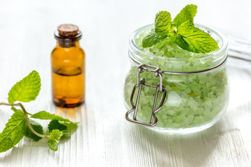 organic cosmetics with herbal extracts of mint on wooden background