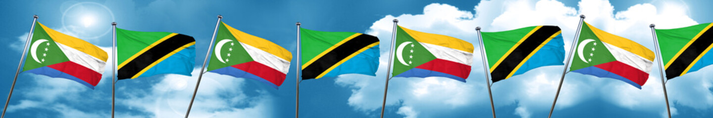 Comoros flag with Tanzania flag, 3D rendering