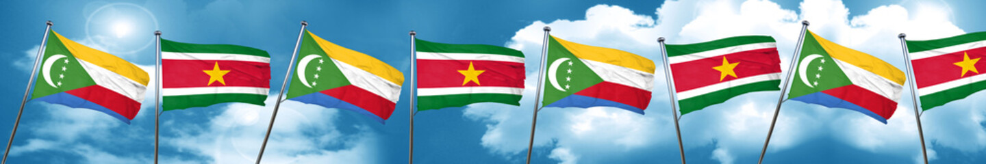 Comoros flag with Suriname flag, 3D rendering