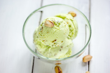 organic homemade ice cream in glass bowl on wooden background
