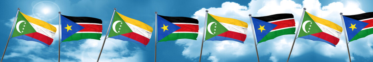 Comoros flag with South Sudan flag, 3D rendering