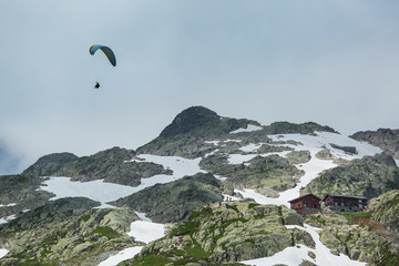 Parasailer flies over the ice and snow in the French Alps above Chamonix.