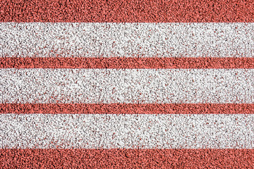 Running track with white paint lines texture.