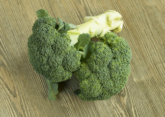 Broccoli gathered in center on wood table