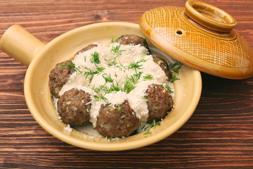 Meatballs with cream sauce in a ceramic pan