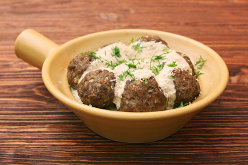 Meatballs with cream sauce in a ceramic pan