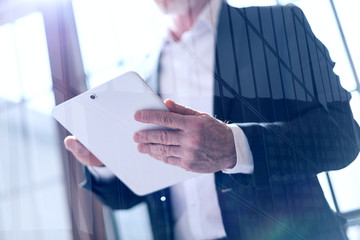 Businessman with tablet, light effect, double exposure