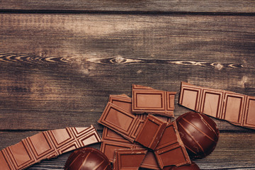 wooden background and broken chocolate bar