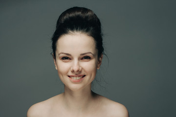 beautiful smile, happy woman on a gray background