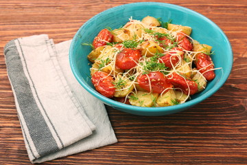 Fried potato and tomato salad with cheese