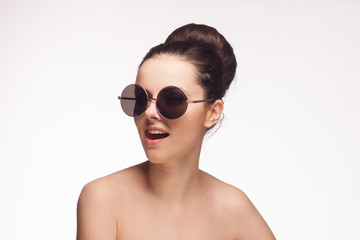 Fototapeta premium beautiful woman in sunglasses on a light background