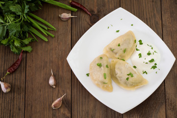 Dumplings with the liver. Wooden background. Top view