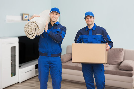 Two Male Movers Standing In House