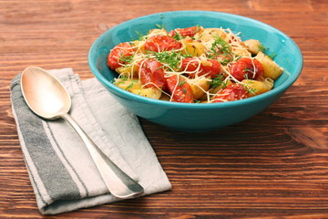 Fried potato and tomato salad with cheese
