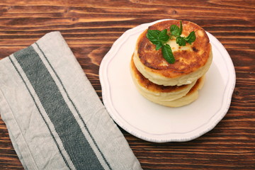 Cheese pancakes fried in a pan.