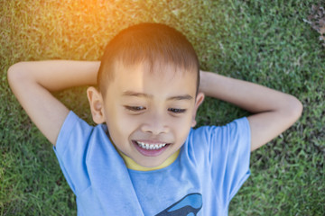 Happy boy child is smiling enjoying adopted life. Portra