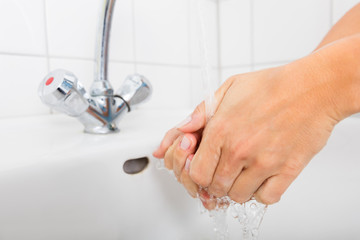 Fototapeta na wymiar Woman Washing Hand In The Basin