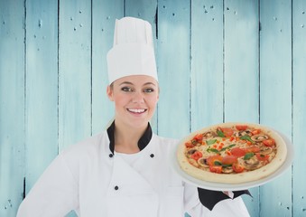 Portrait of female chef holding pizza in plate