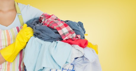 Mid section of woman holding bucket full of clothes © vectorfusionart